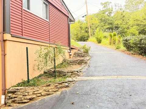Landscaping and planting strip alongside a paved residential driveway